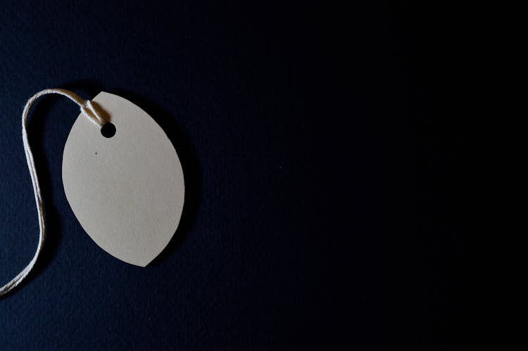 White Tag With String And Black Background