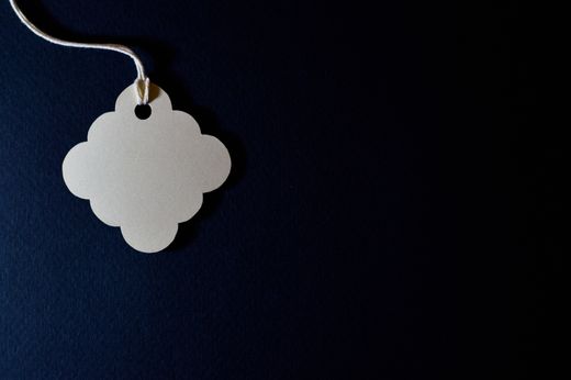 Blank paper hang tag on a dark surface — photo by Miguel Á. Padriñán on Pexels