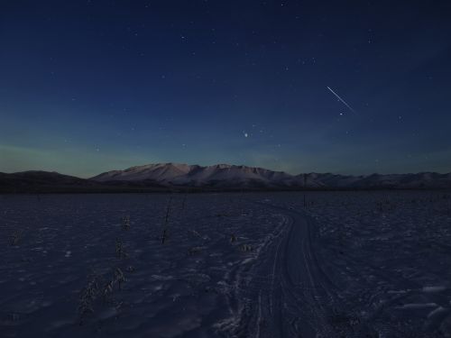 Free Stunning starry night sky over snowy mountains near Yakutsk, Russia. Stock Photo