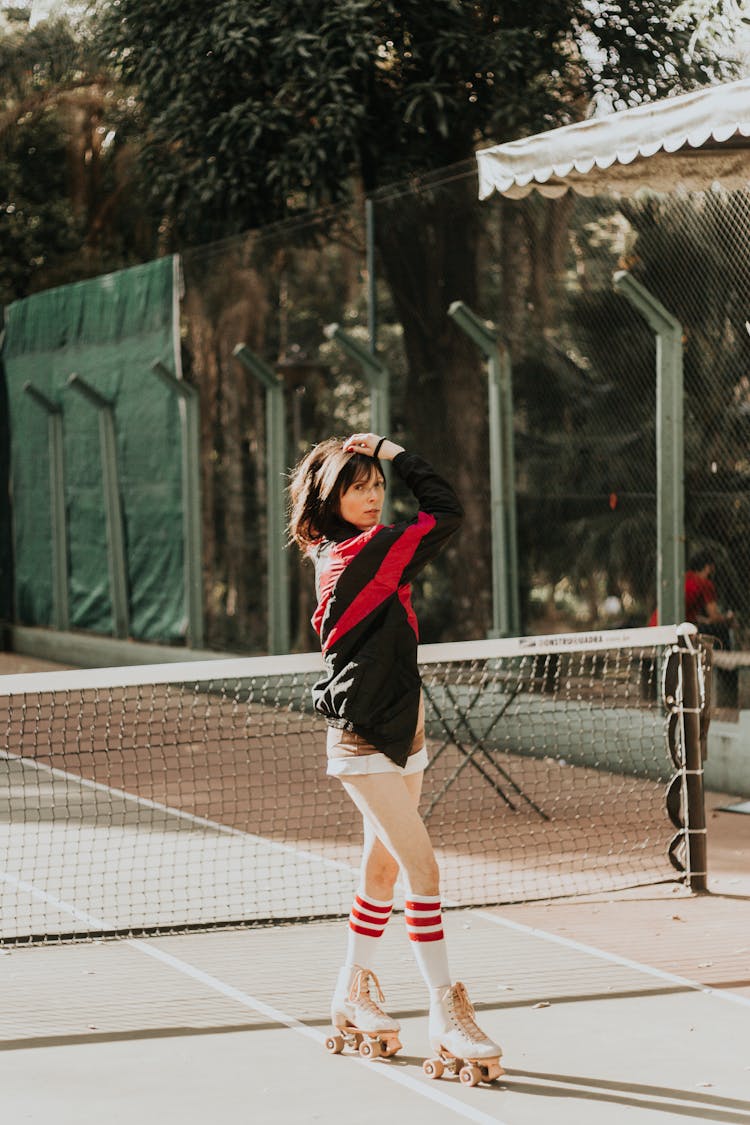 Woman On Rollerskates In Tennis Court