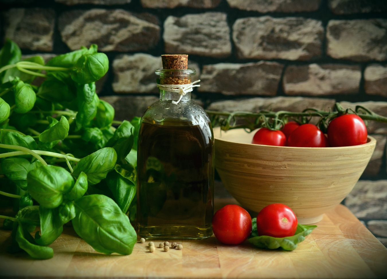 Nutrient-rich foods displayed on a wooden table, including fruits, vegetables, and nuts.