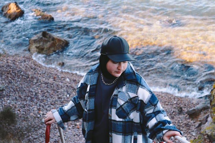 Woman Wearing A Black Cap And A Flannel Shirt