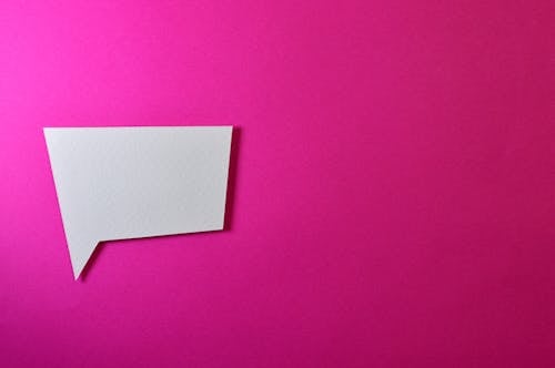 Free White Chat Logo on Pink Background Stock Photo