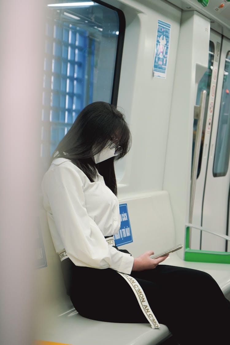 Woman Using Her Phone Inside The Train