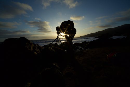 Man Taking Picture of the Ocean