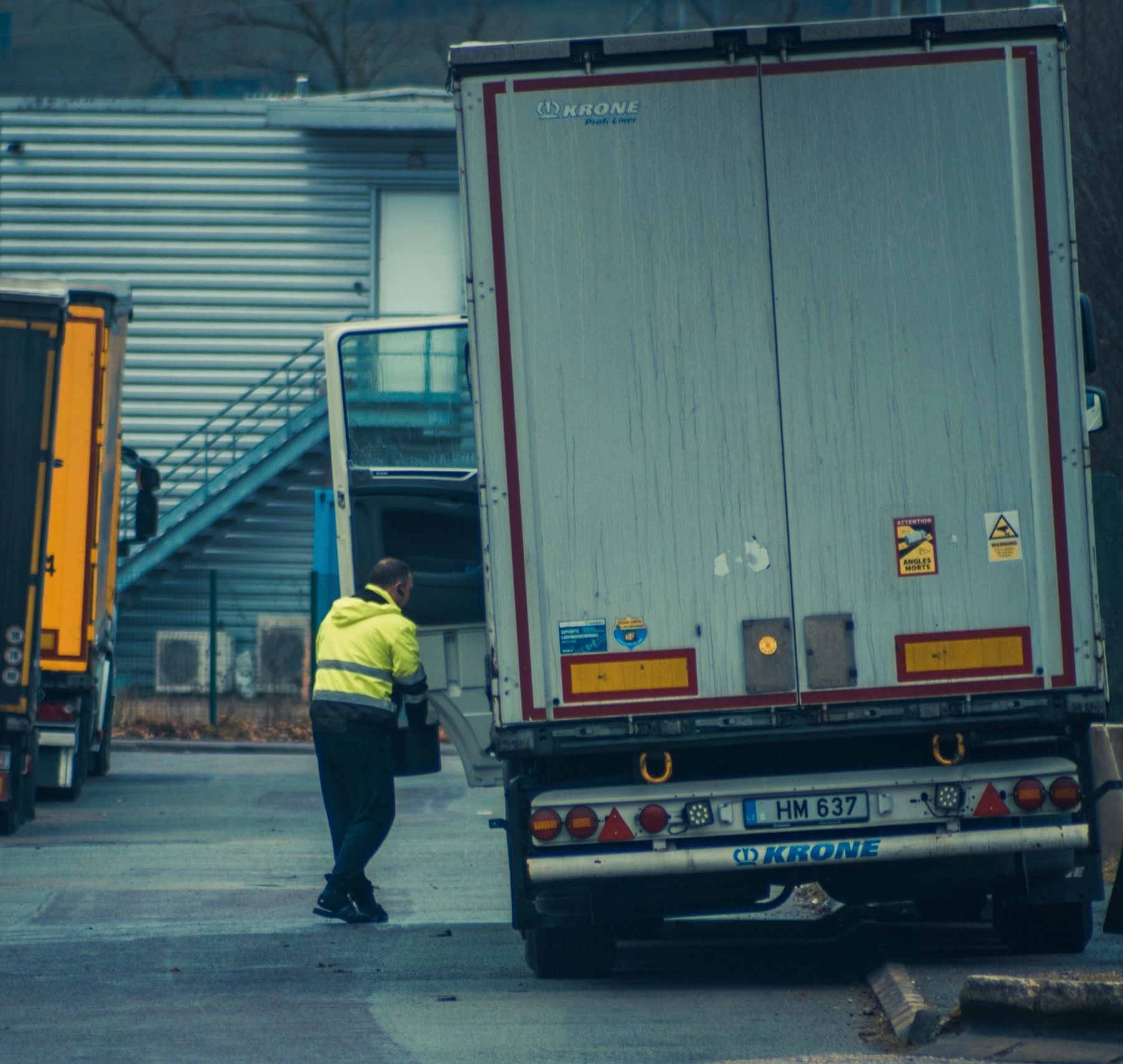 Commercial truck driver working beside a freight truck