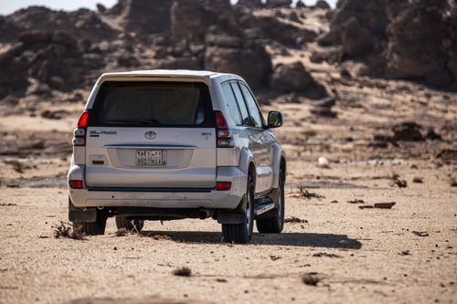 Free A Toyota Prado SUV parked in a rugged desert landscape, showcasing adventure and off-road capability. Stock Photo