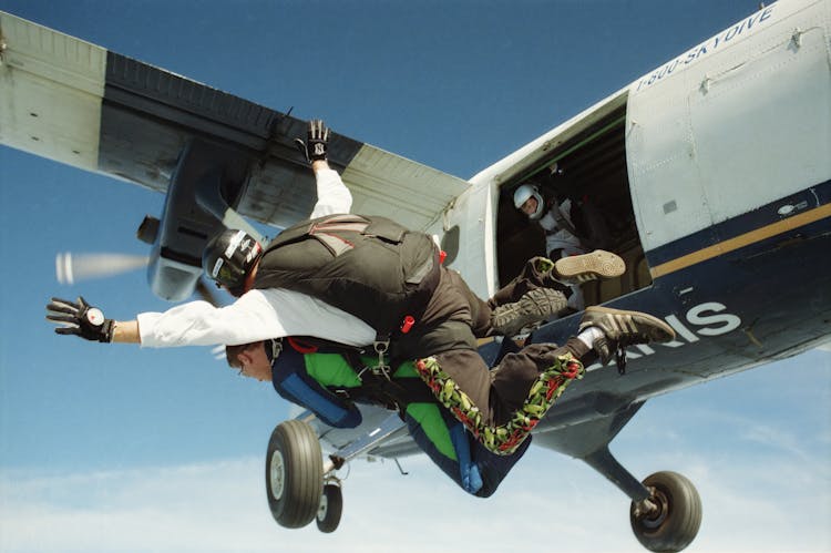 Photo Of Skydivers Near An Airplane