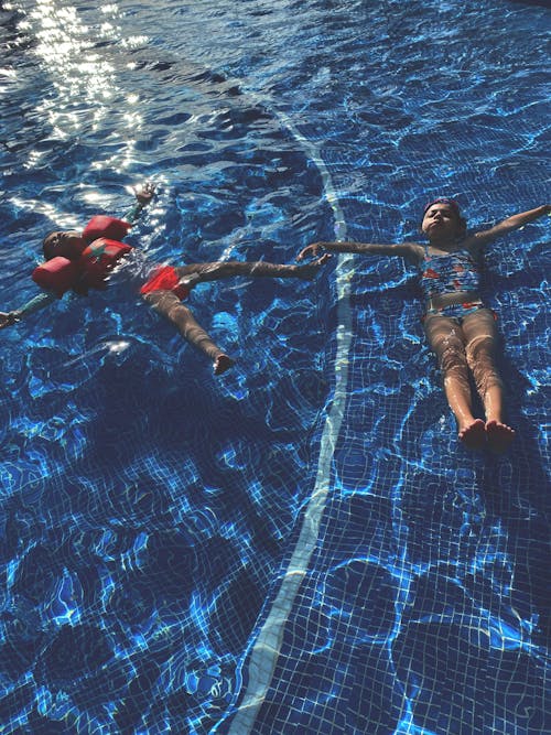 Children Relaxing in a Swimming Pool