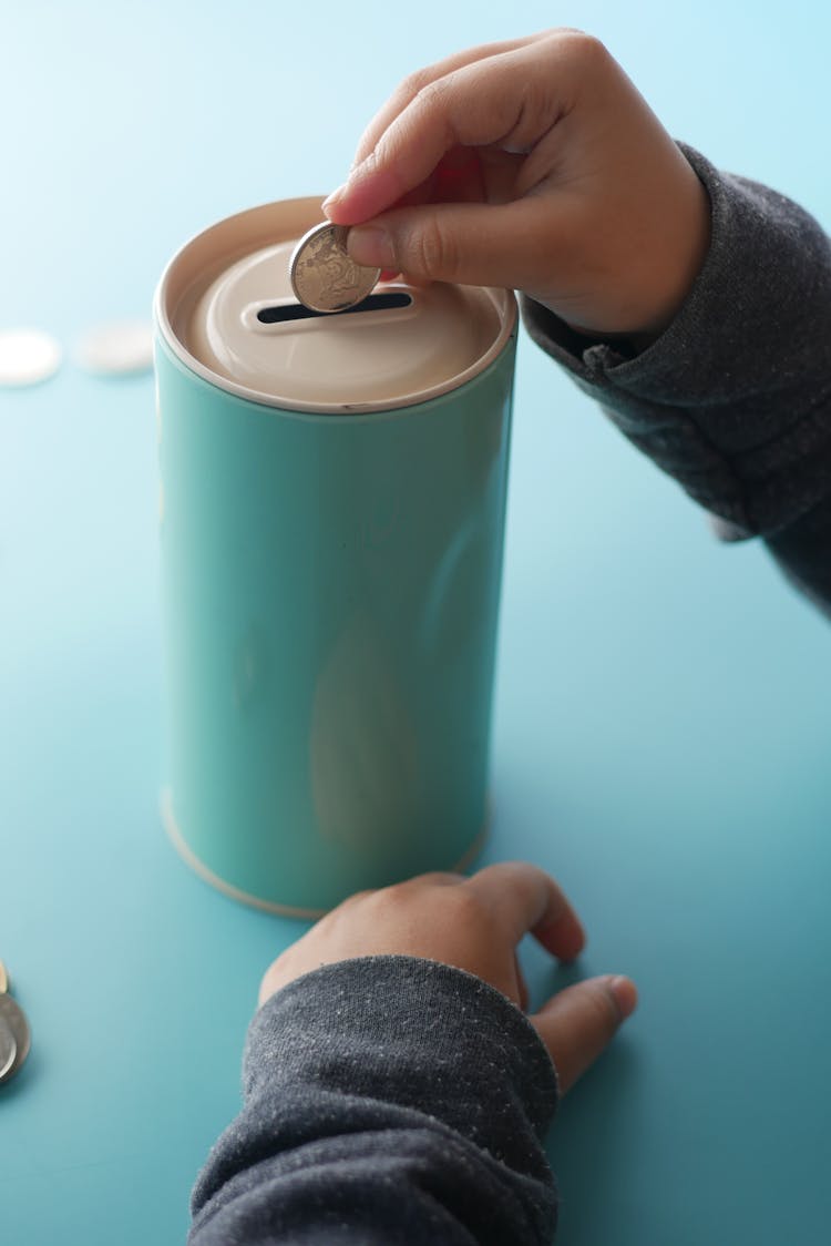 Close-up Of Putting A Coin On A Can