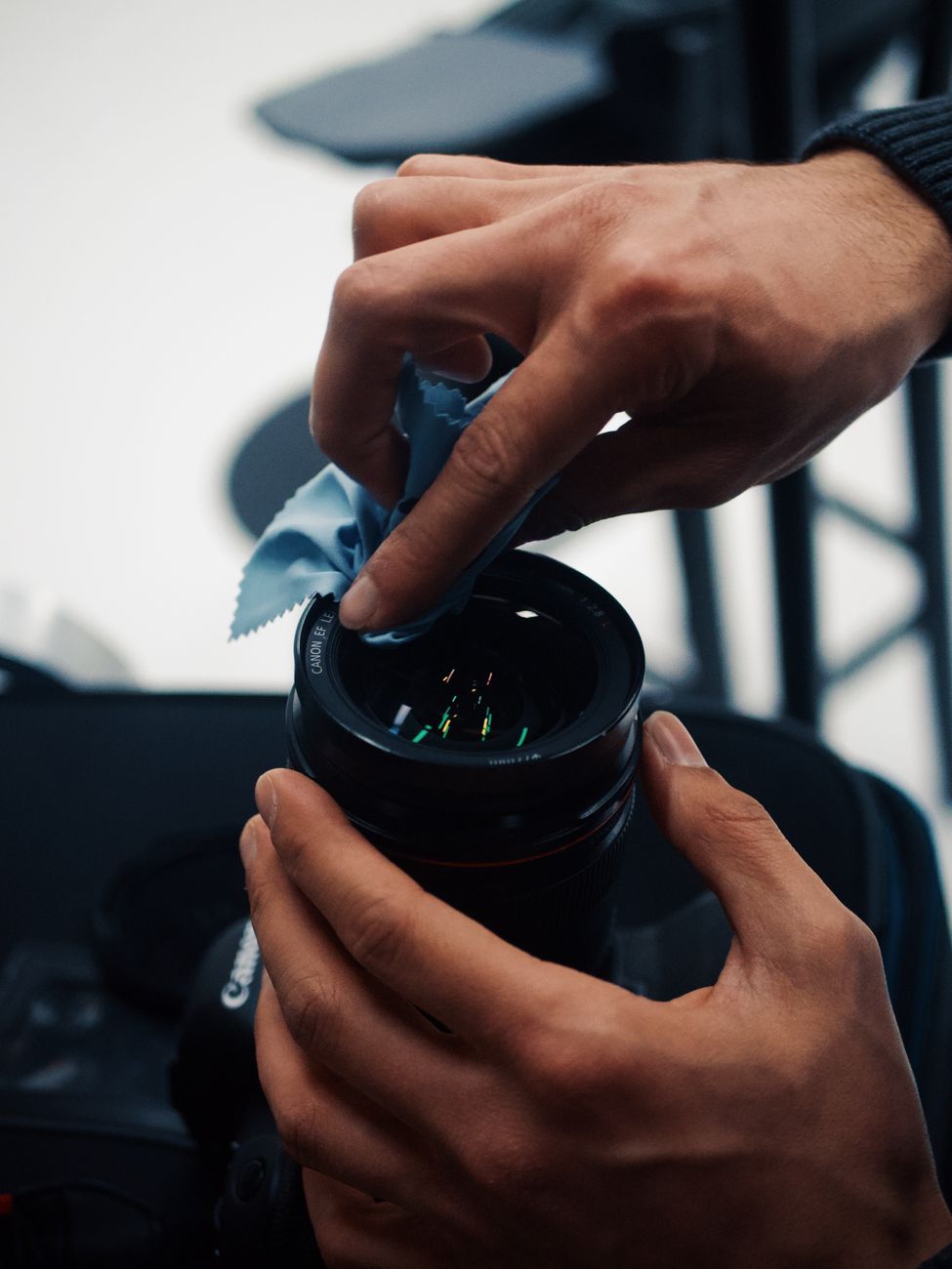 Camera lens being cleaned with a microfiber cloth