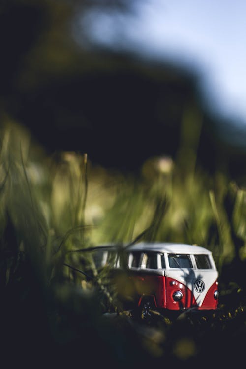 Shallow Focus Photography of White and Red Volkswagen Samba Die-cast Model