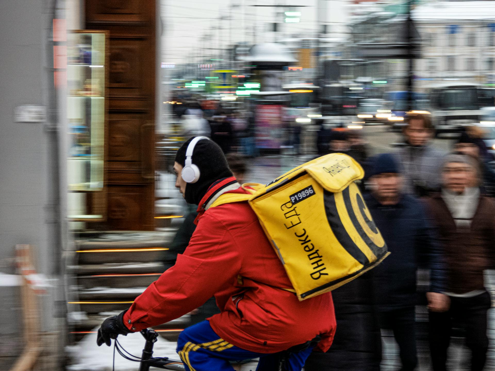 Dynamic street scene with a bicycle courier in winter, capturing the hustle of city life.