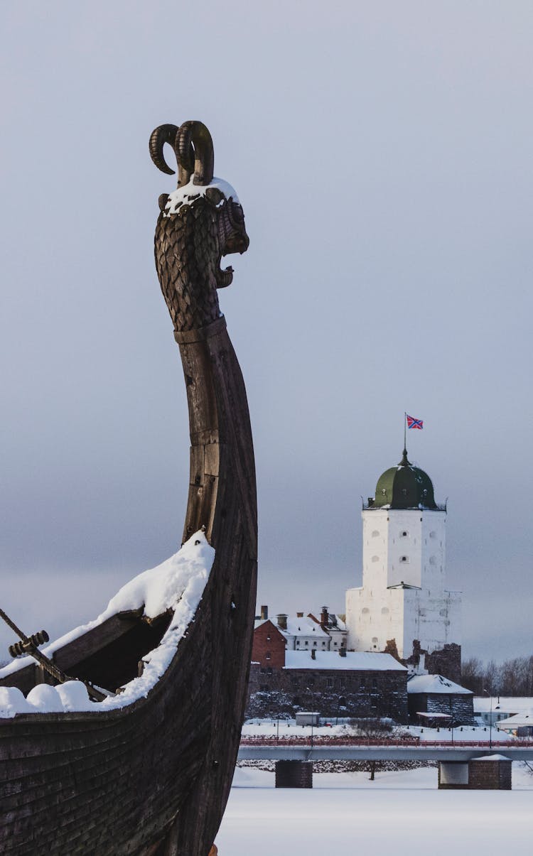 Viking Longboat And Lighthouse Behind