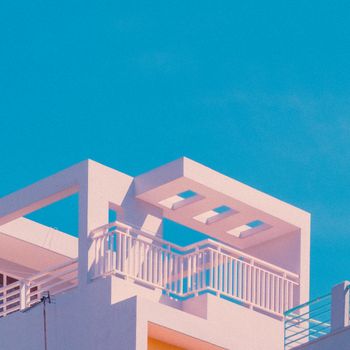 Bright, minimalist architectural design with clear blue sky background