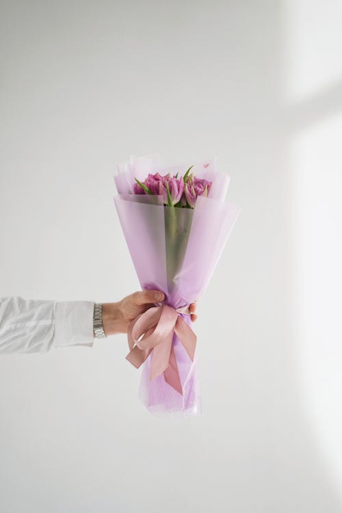 Hand Holding Bunch of Pink Flowers · Free Stock Photo
