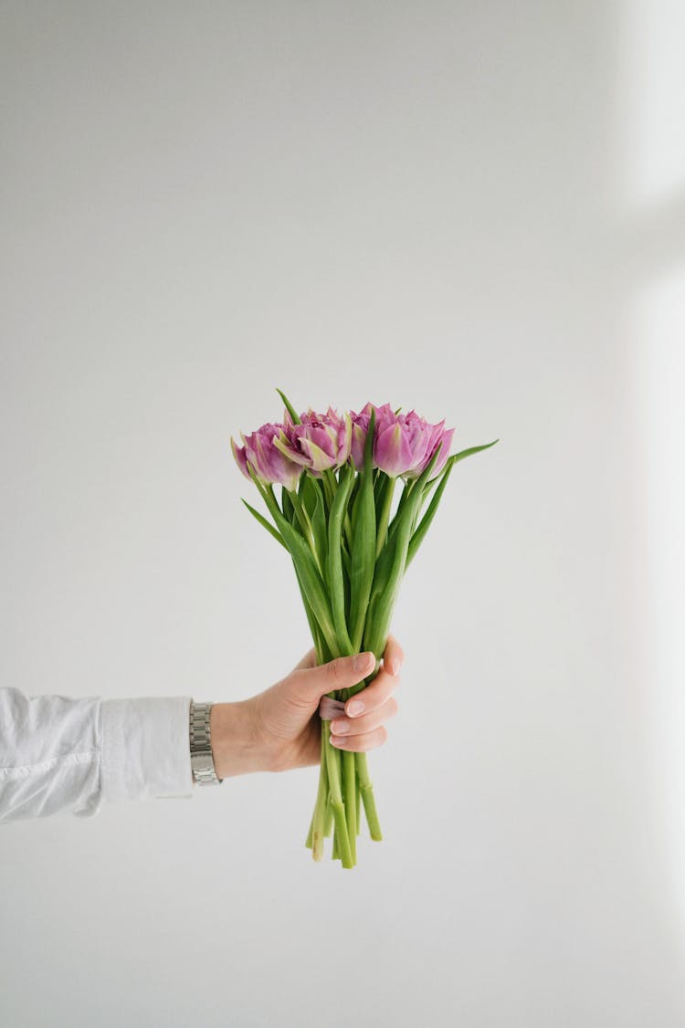 Unrecognizable Male Hand Holding Bunch Of Flowers