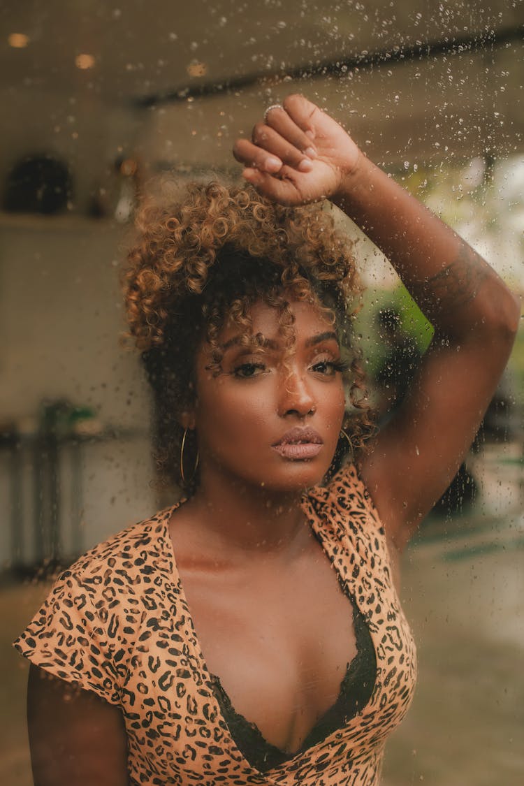 Woman Leaning On Glass Wet From Rain