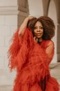 Woman with Curly Hair Wearing Red Peignoir