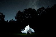 White Textile on Green Grass Field during Night Time