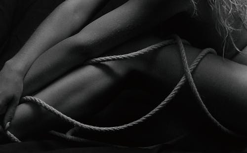 Free Grayscale Photo of a Person Leg with Rope Stock Photo