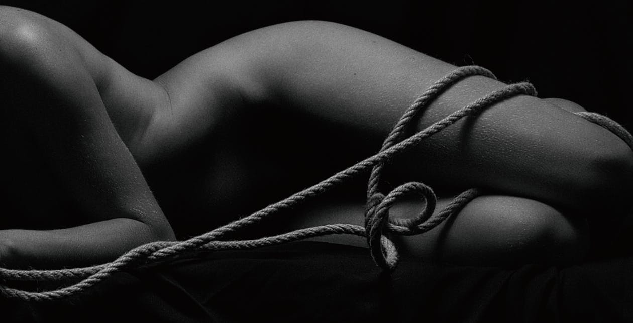 Grayscale Photo of a Naked Body with a Rope