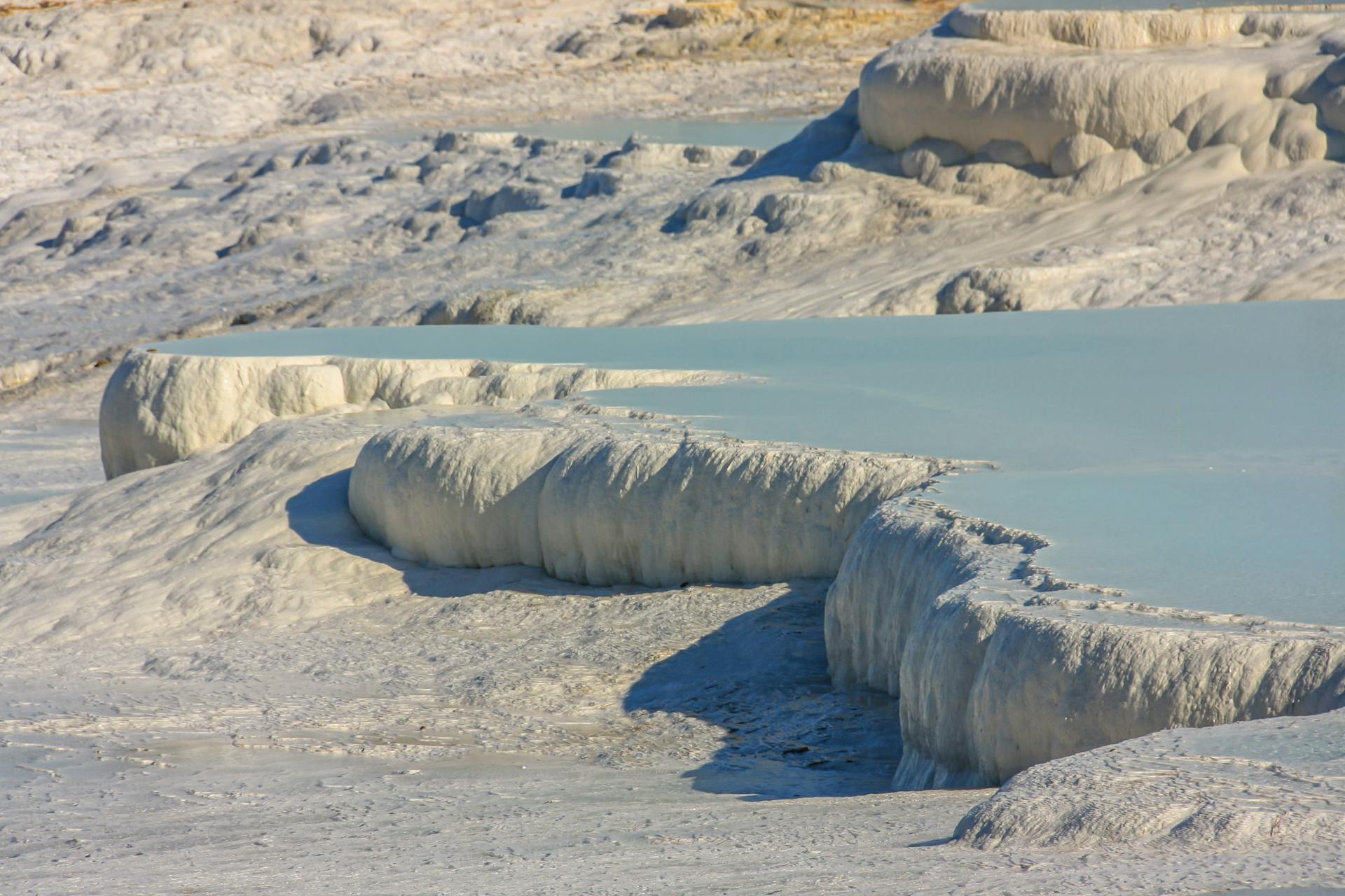 Beautiful view of layered terraces formed by mineral deposits in an arid region.