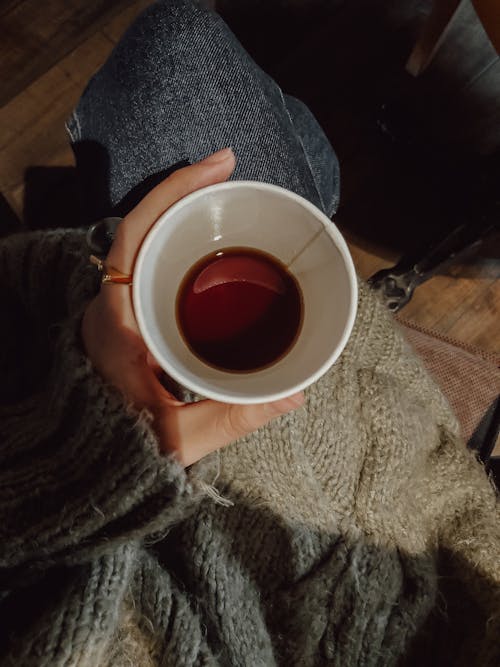 Woman Holding a Disposable Cup with Coffee 