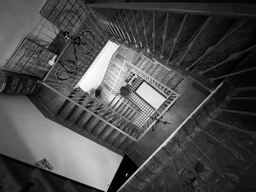 Grayscale Photograph of a Staircase with Bikes