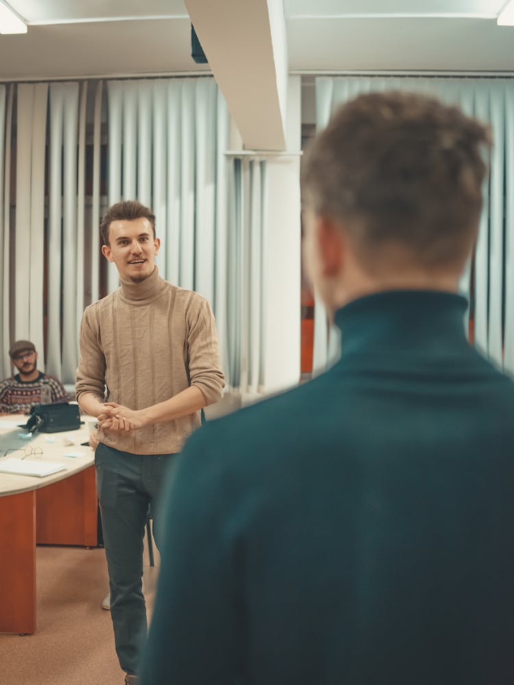 Male Co-Workers Talking At The Office