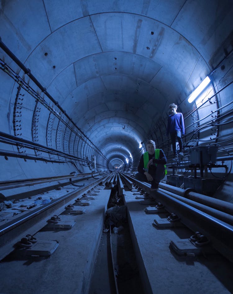 People Walking On Gray Tunnel