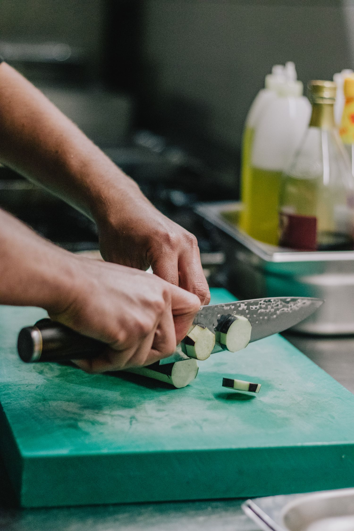 Kitchen knife cutting vegetables on a preparation board