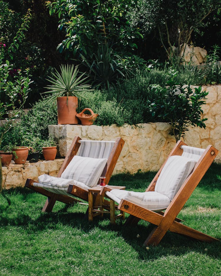 Lush Green Garden With Deck Chairs In Summer