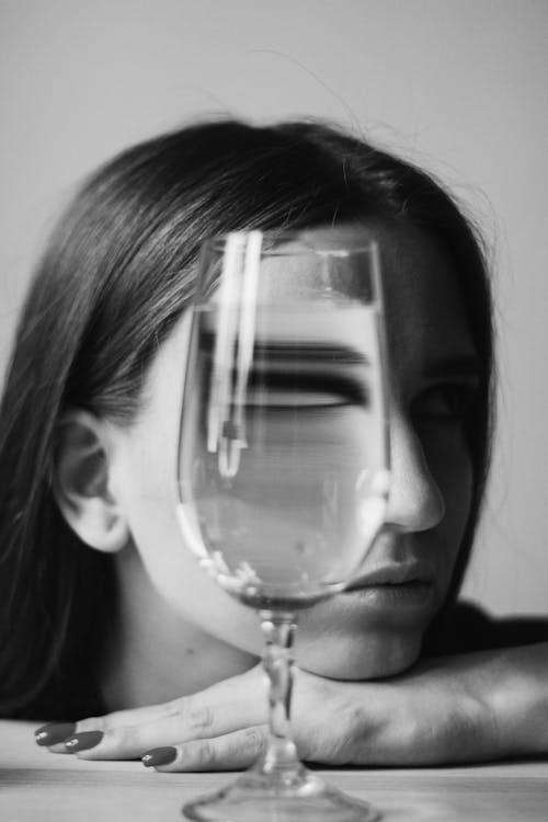 Free Woman with Face Obscured by Glass of Beverage Stock Photo
