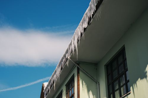 Free Icicles hanging from a roof in Mudurnu, Bolu on a clear winter day. Stock Photo
