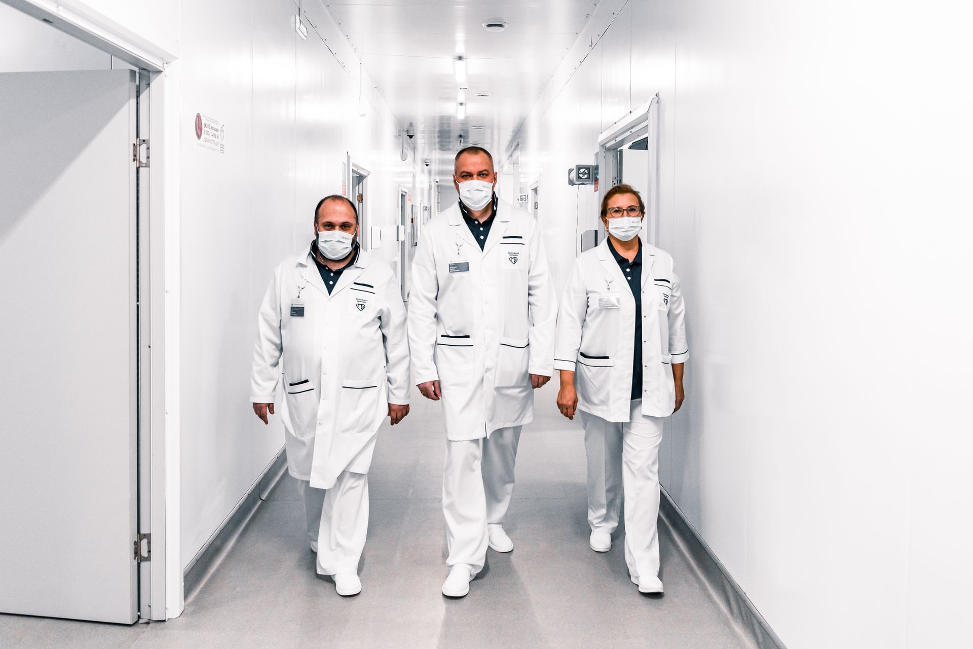 Healthcare professionals moving together through a hospital corridor
