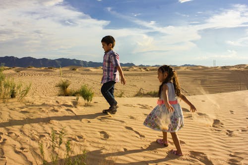 Photo of Kids Walking on Sand