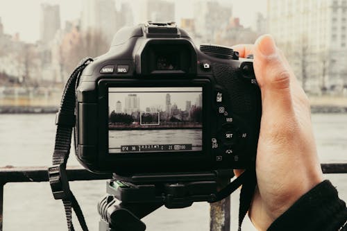 Person Holding a Black Camera 