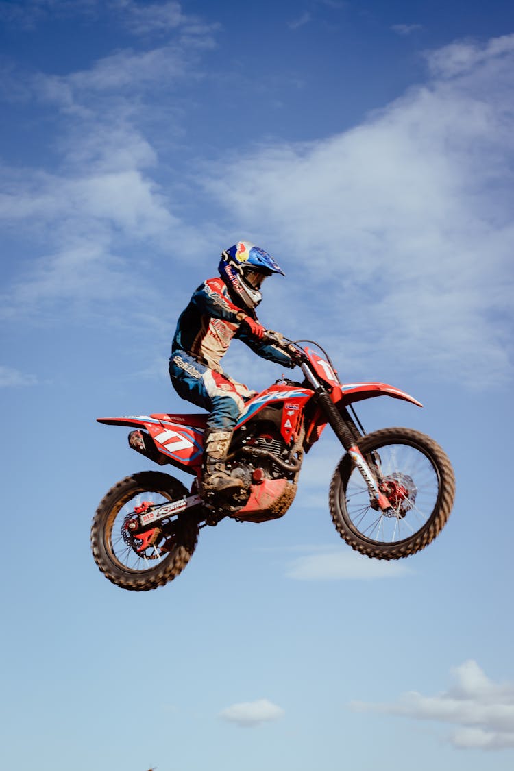 Motorcycle Racer During Jump Against Sky