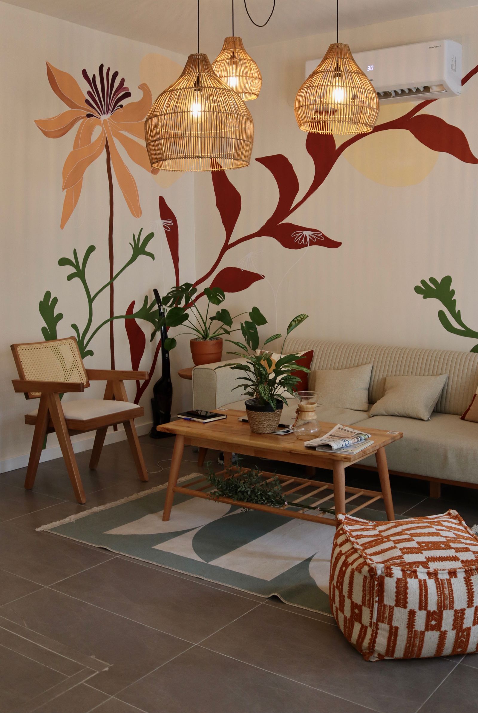 Living room with armchairs and woven pendants