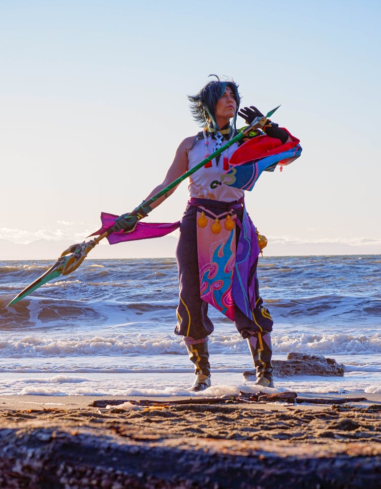 Woman Holding A Spear At The Beach