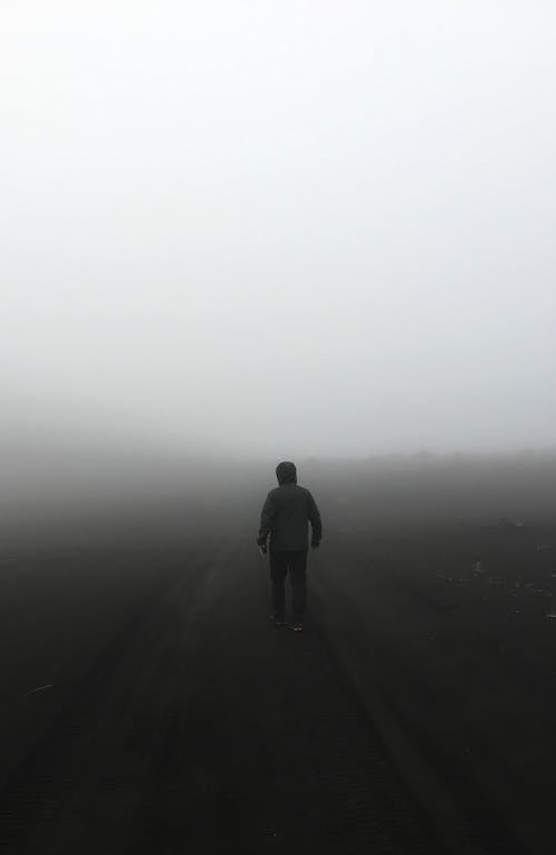 A Person Standing in a Fog