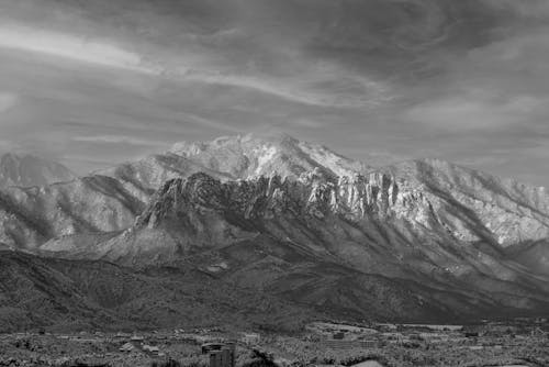 Black and White Photo of Mountains in Winter 