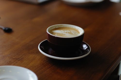 Free Cup of Coffee over a Wooden Table Stock Photo
