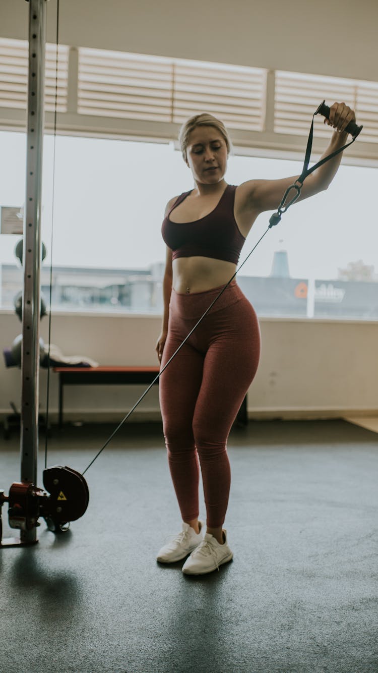 A Woman Working Out In The Gym