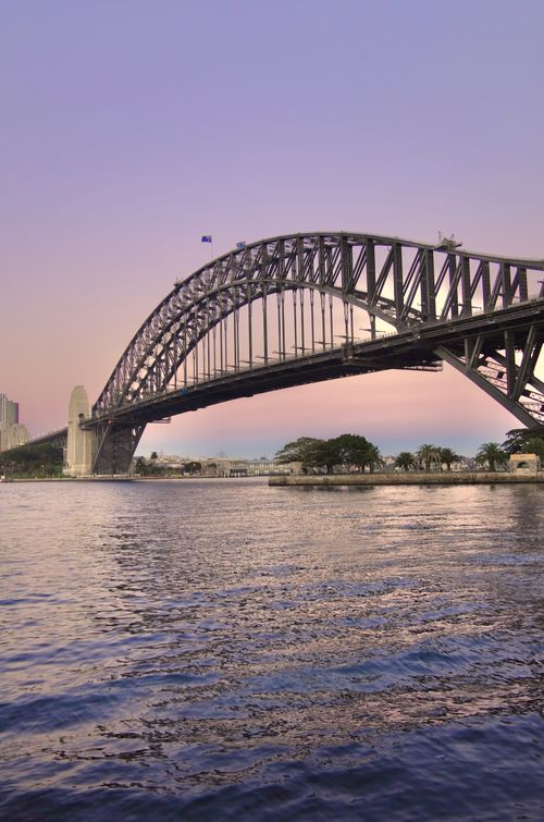 Free Captivating view of Sydney Harbour Bridge at sunrise with reflection on still water. Stock Photo