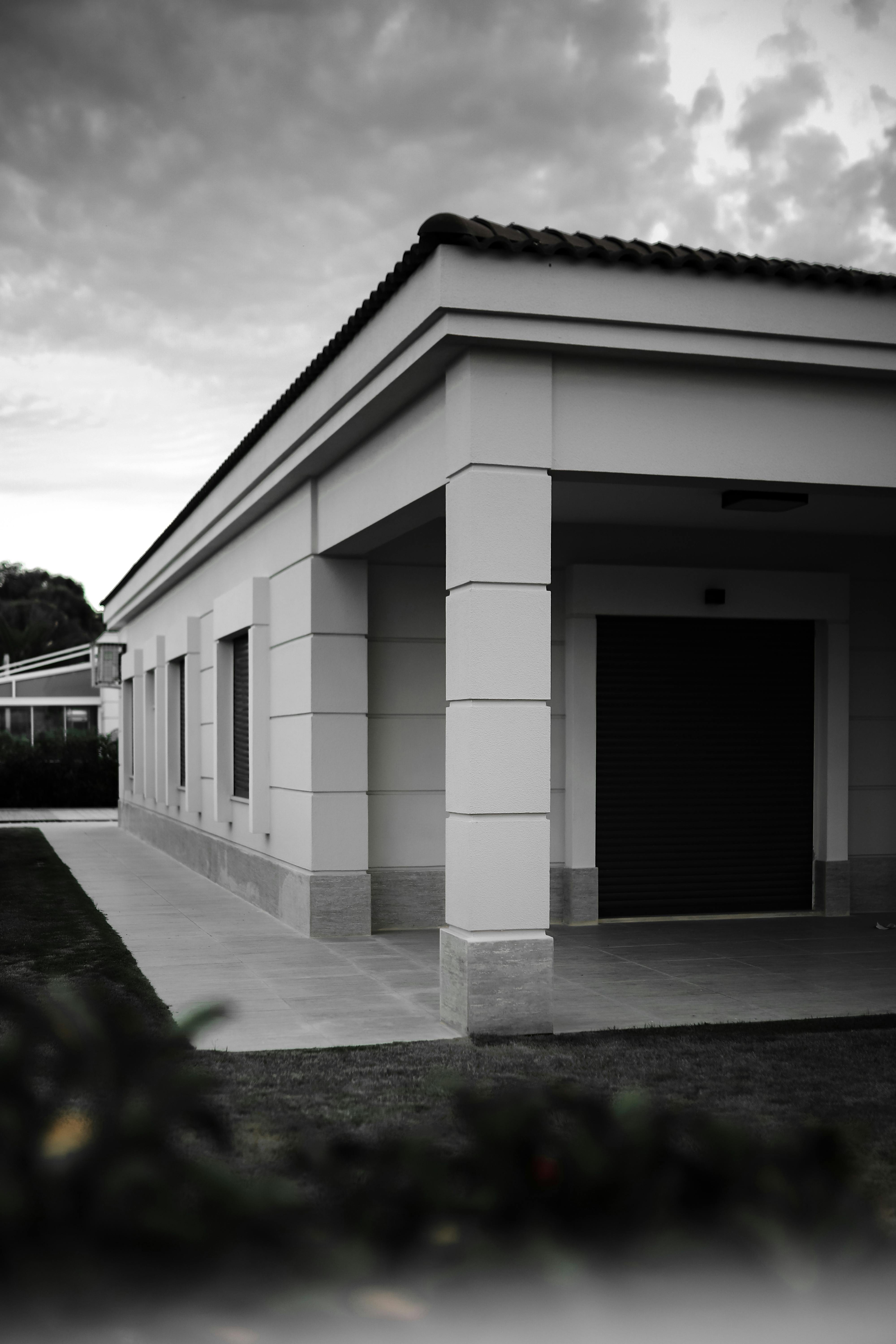 White Concrete Building Under White Clouds
