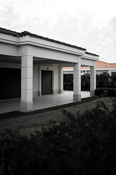 Elegant villa exterior in İzmir featuring a covered patio and lush garden.