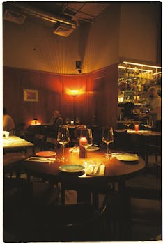 Intimate eatery with ambient lighting and elegant table settings.