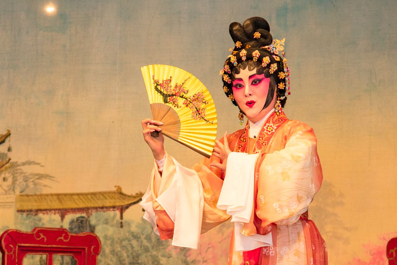 a performer in traditional chinese opera costume with elaborate makeup